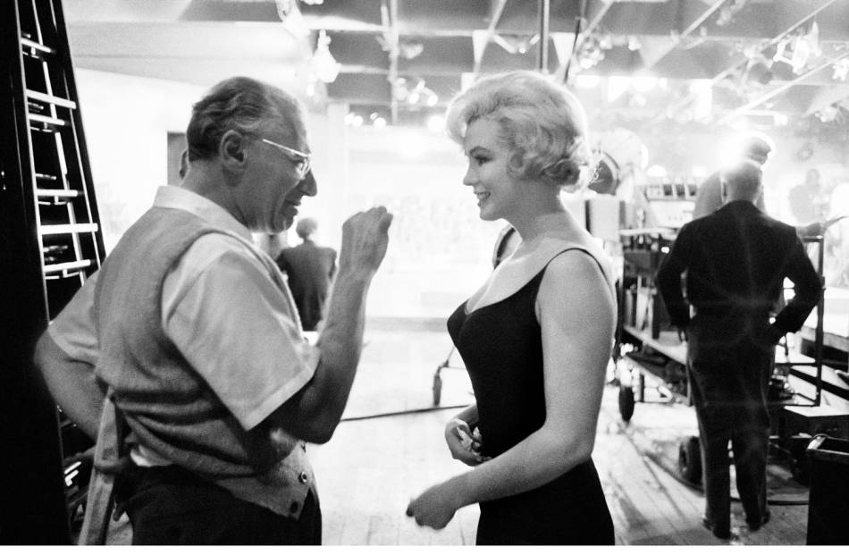 Marilyn Monroe listens to director George Cukor on the set of Lets Make Love Hollywood 1960